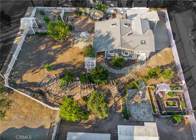 a view of a patio with couches table and chairs under an umbrella