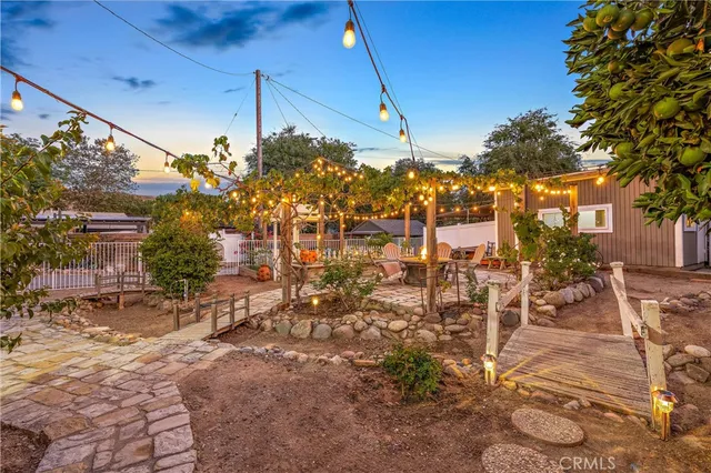 a backyard of a house with table and chairs