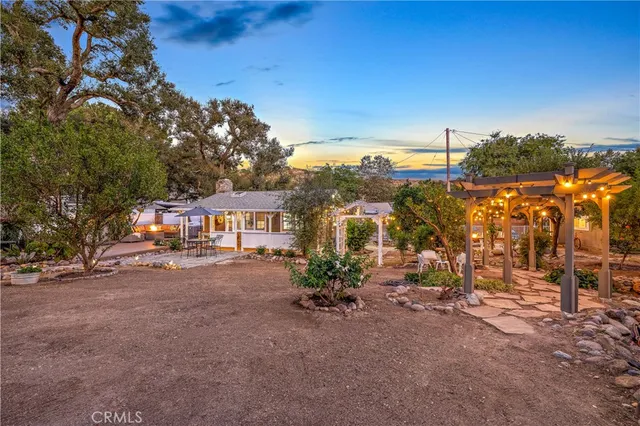 a view of a field with trees in the background