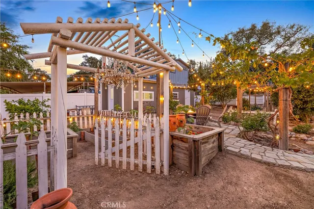 a view of a patio with a table and chairs and potted plants
