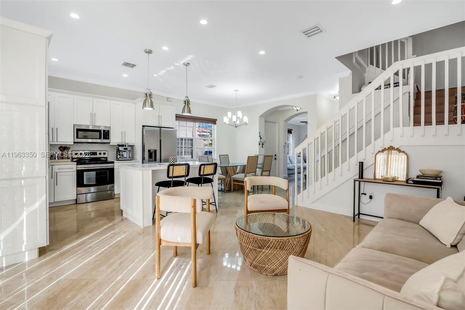 12464 Southwest 42nd Street Miramar, FL 33027 - Photo 12 of 40 a living room with fireplace furniture and a kitchen view