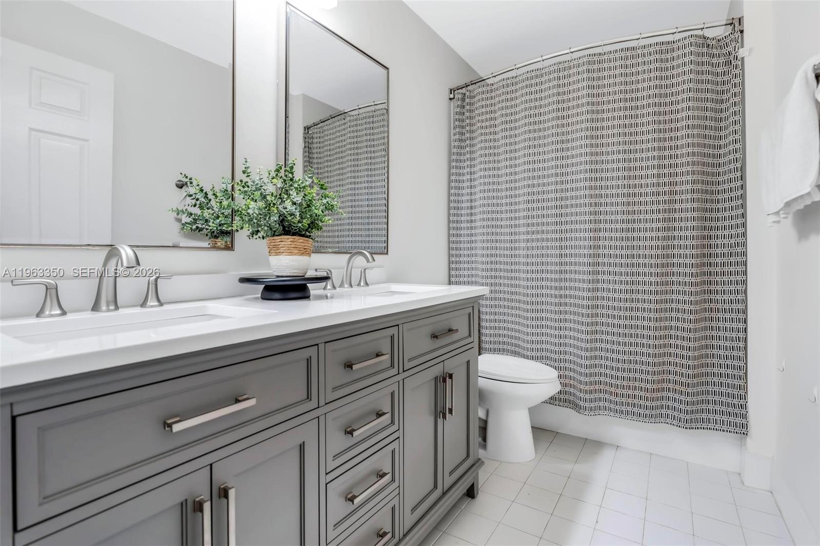 12464 Southwest 42nd Street Miramar, FL 33027 - Photo 21 of 40 a bathroom with a toilet a sink and mirror