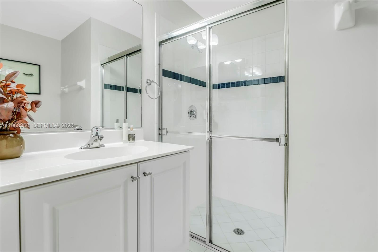 12464 Southwest 42nd Street Miramar, FL 33027 - Photo 23 of 40 a bathroom with a shower sink and mirror