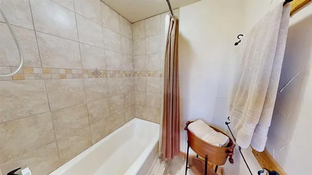 a bathroom with a tub and a shower