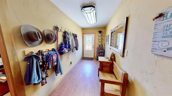 a view of an entryway with wooden floor