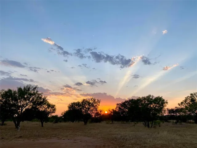 a sunset view with a lake