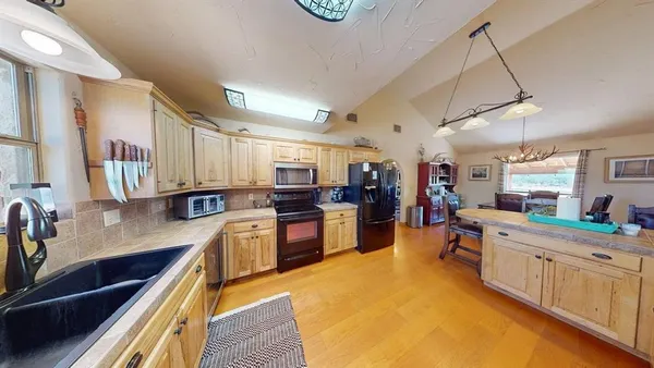 a large kitchen with a large counter top appliances and cabinets