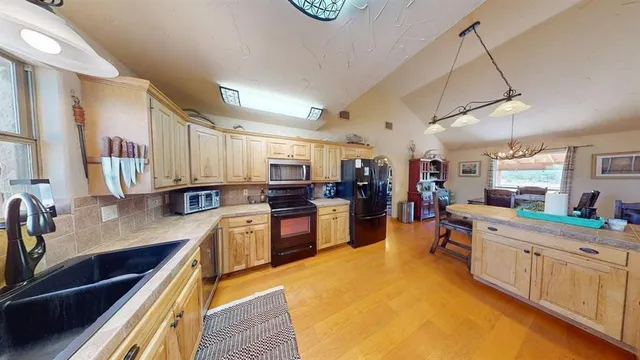 a large kitchen with a large counter top appliances and cabinets