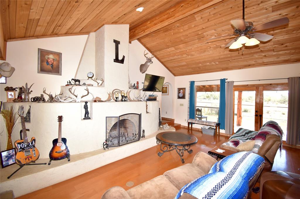19319 Ranch Road 1871 Mason, TX 76856 - Photo 7 of 40 a living room with furniture a fireplace and a chandelier