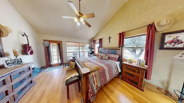 a bedroom with bed and wooden floor