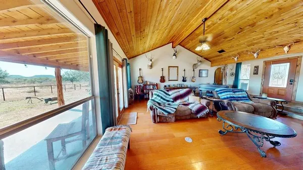 a living room with furniture a rug water view and a large window