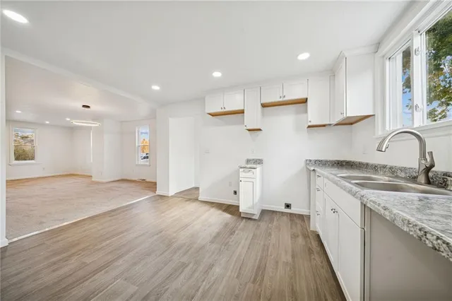 a view of a kitchen with wooden floor and electronic appliances