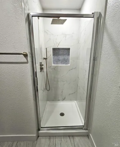 a bathroom with a glass shower door