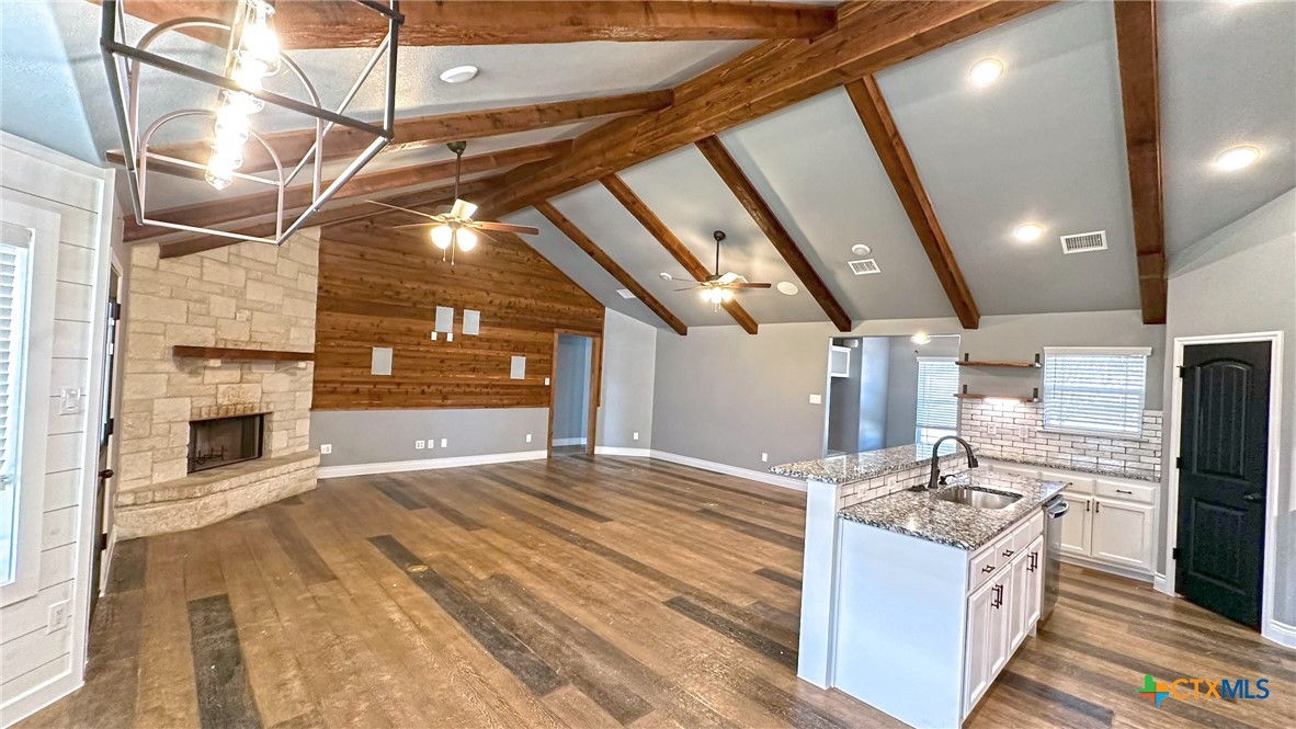 1142 Lutheran Church Road Copperas Cove, TX 76522 - Photo 15 of 48 a kitchen with kitchen island granite countertop a stove and a sink