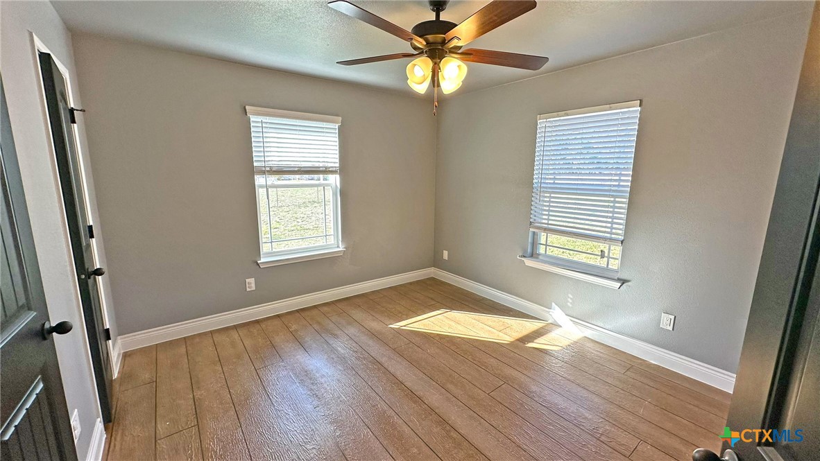 1142 Lutheran Church Road Copperas Cove, TX 76522 - Photo 21 of 48 a view of empty room with wooden floor and fan