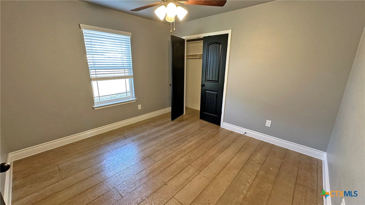 1142 Lutheran Church Road Copperas Cove, TX 76522 - Photo 23 of 48 a view of an empty room with wooden floor and a window