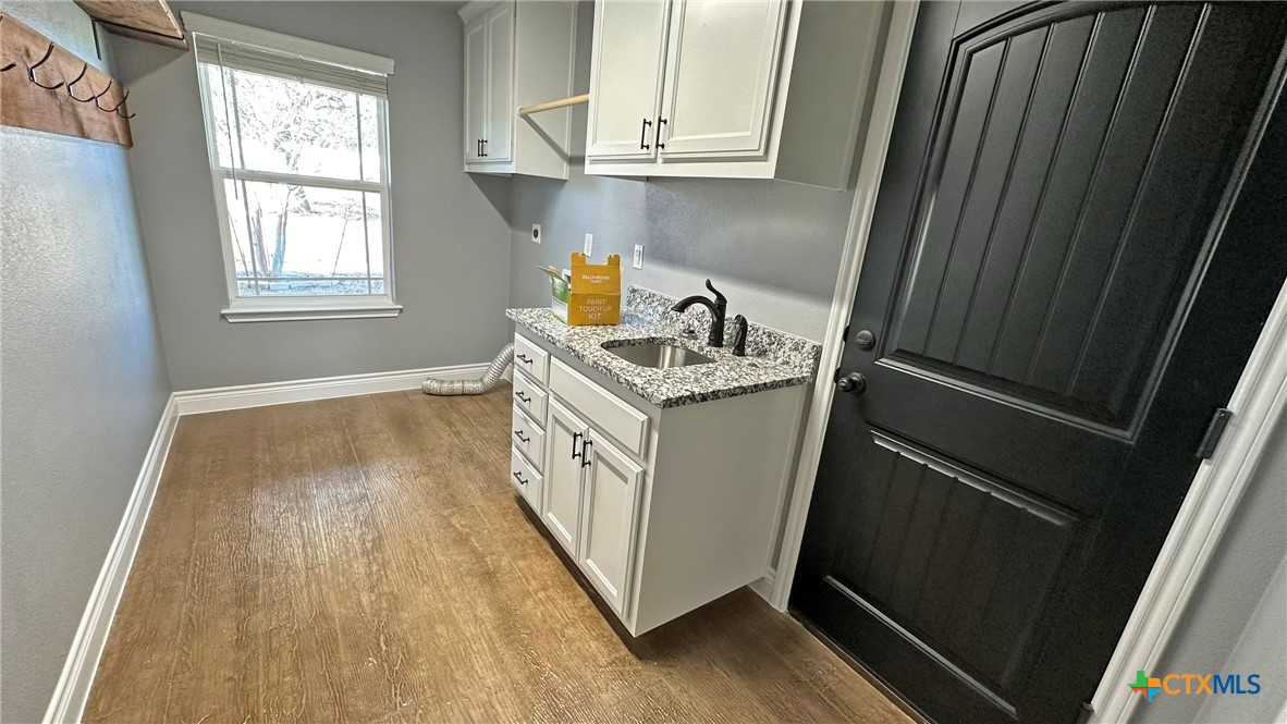 1142 Lutheran Church Road Copperas Cove, TX 76522 - Photo 30 of 48 a utility room with wooden floor washer and dryer