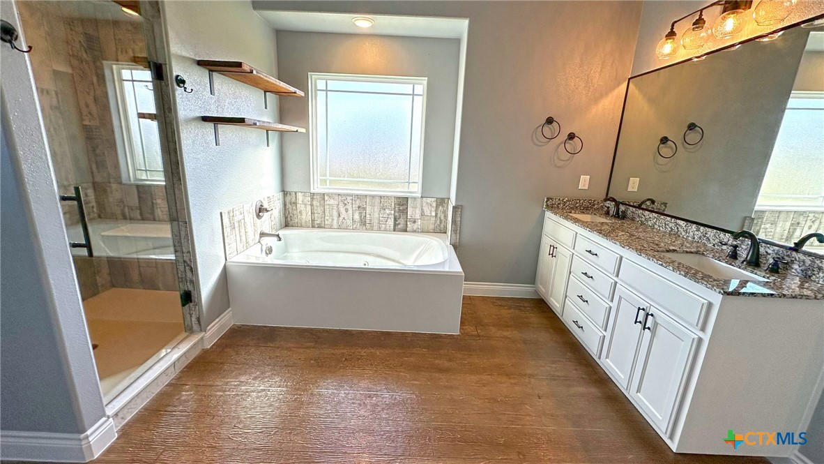 1142 Lutheran Church Road Copperas Cove, TX 76522 - Photo 32 of 48 a bathroom with a tub sink and mirror