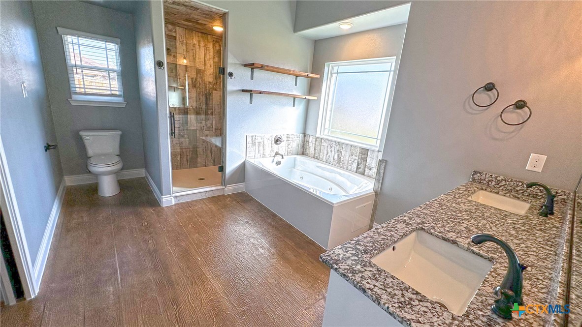 1142 Lutheran Church Road Copperas Cove, TX 76522 - Photo 33 of 48 a spacious bathroom with a tub sink and a toilet
