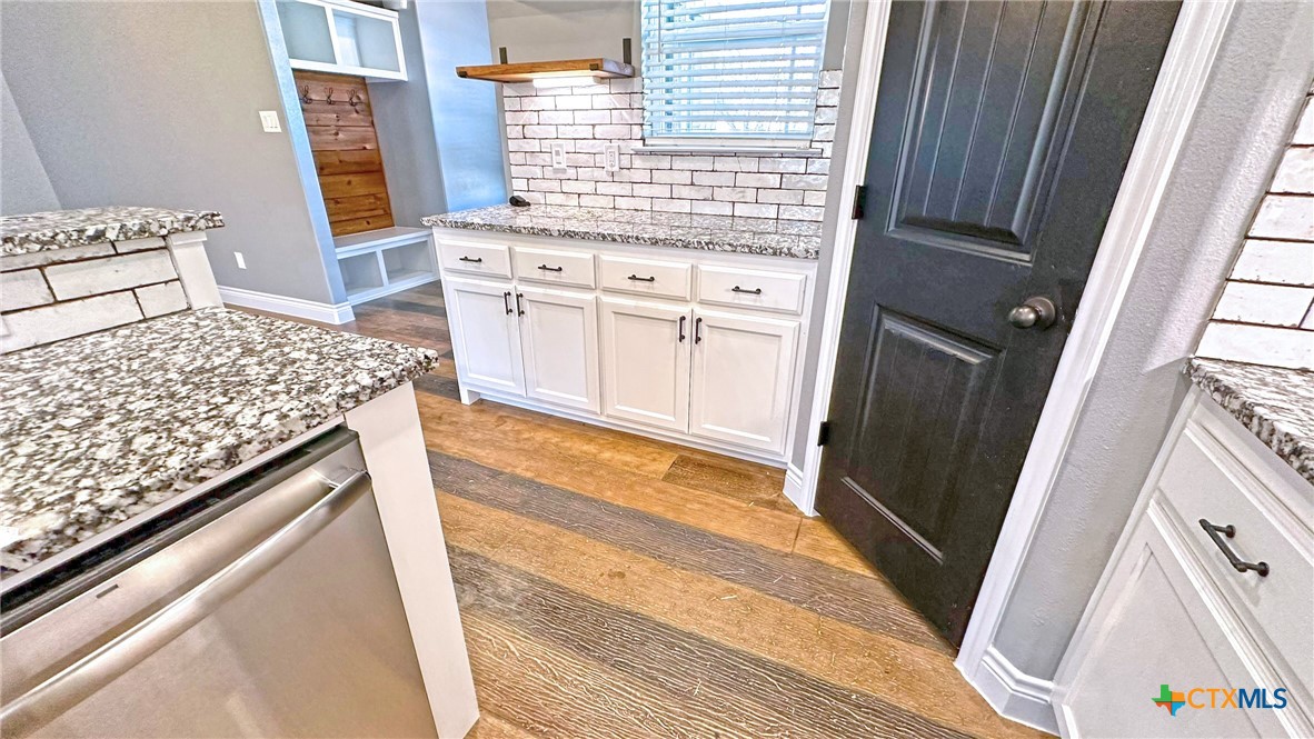 1142 Lutheran Church Road Copperas Cove, TX 76522 - Photo 9 of 48 a kitchen with white cabinets and sink