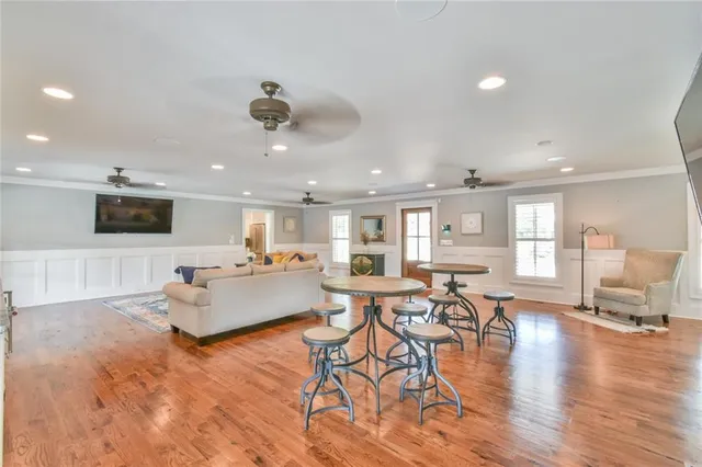 a living room with furniture and a wooden floor