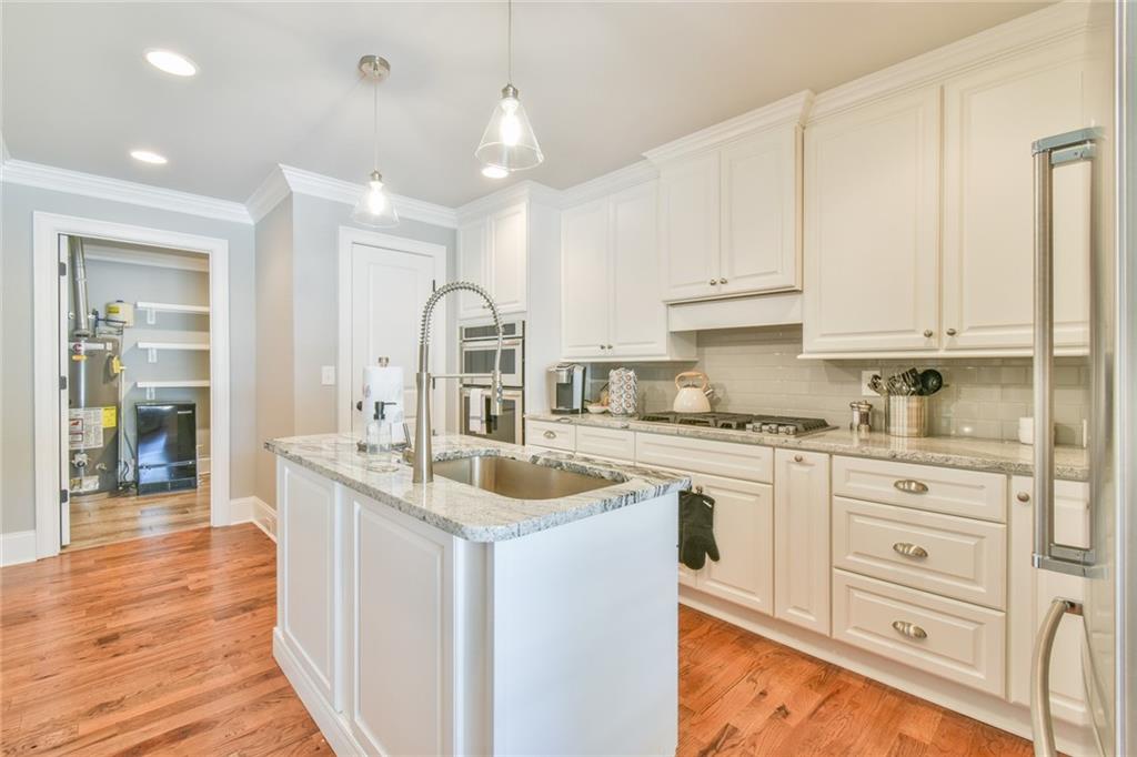 1060 A Bertram Road Augusta, GA 30909 - Photo 17 of 30 a kitchen with granite countertop a sink stainless steel appliances and white cabinets