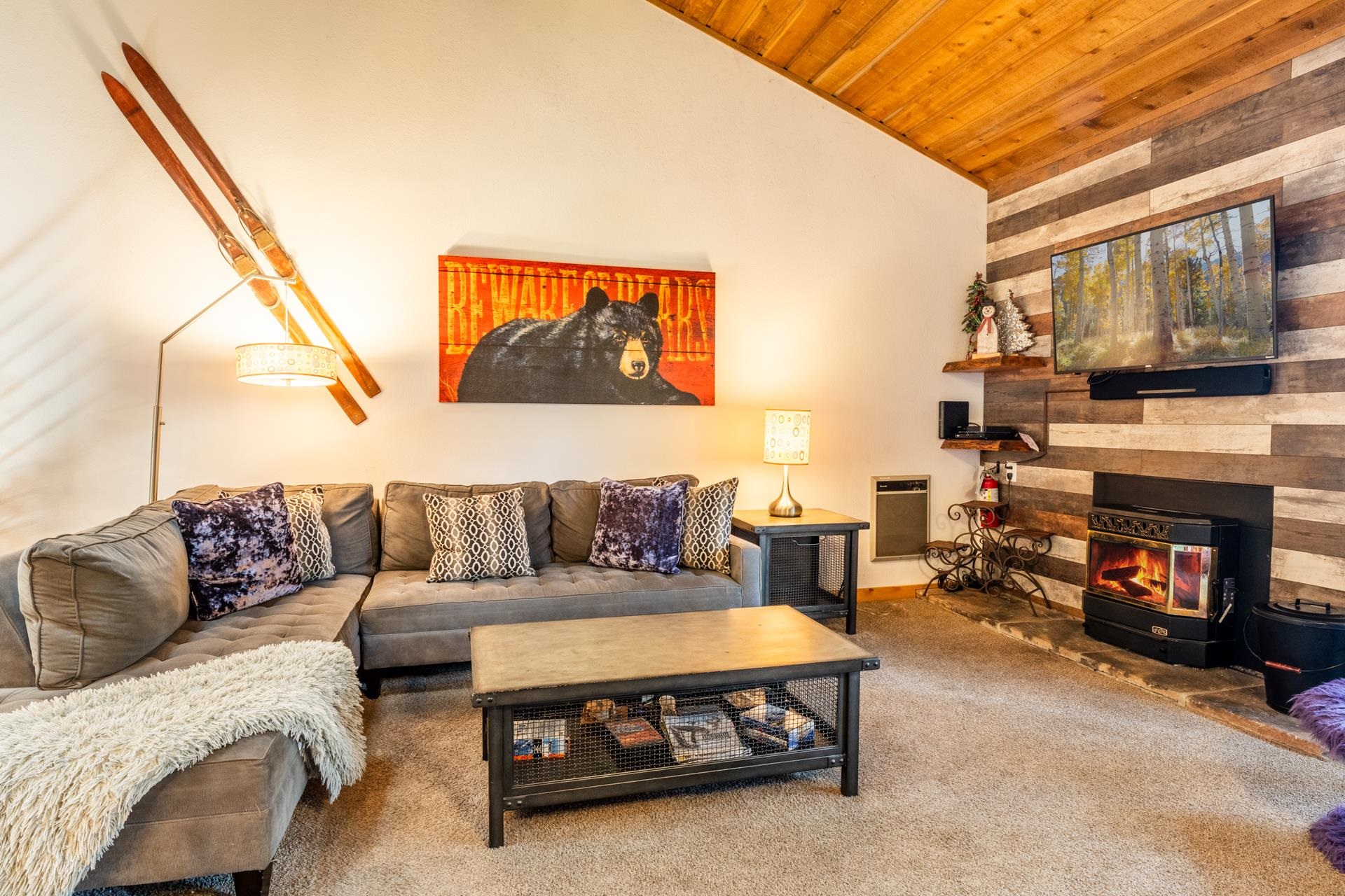 a living room with furniture a flat screen tv and a fireplace