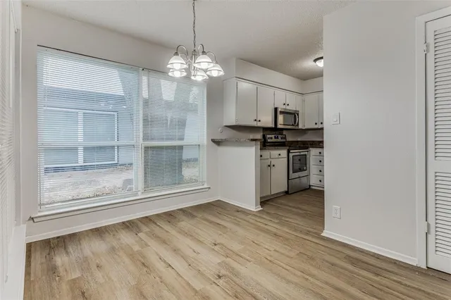 a view of a kitchen with a sink a dishwasher and wooden floor
