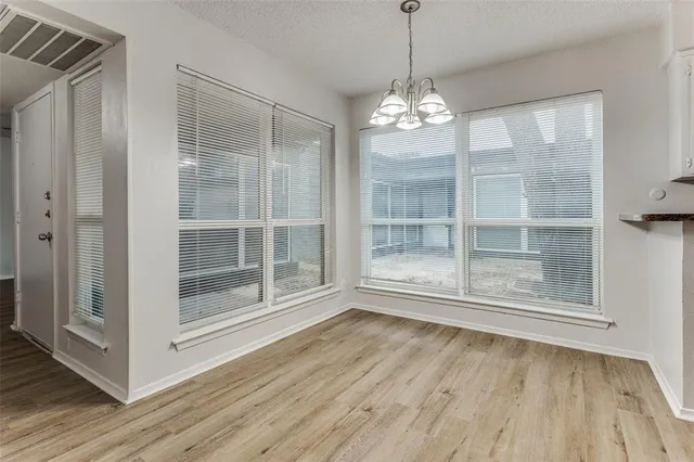 a view of a room with wooden floor and door