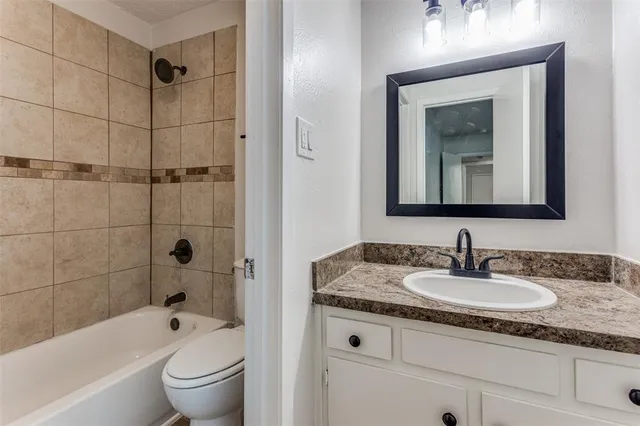 a bathroom with a toilet a sink a mirror a bathtub and shower