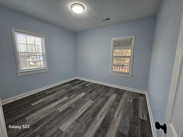 a view of an empty room and a window