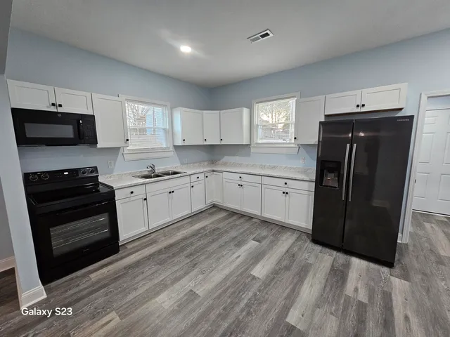a kitchen with a sink a stove and refrigerator