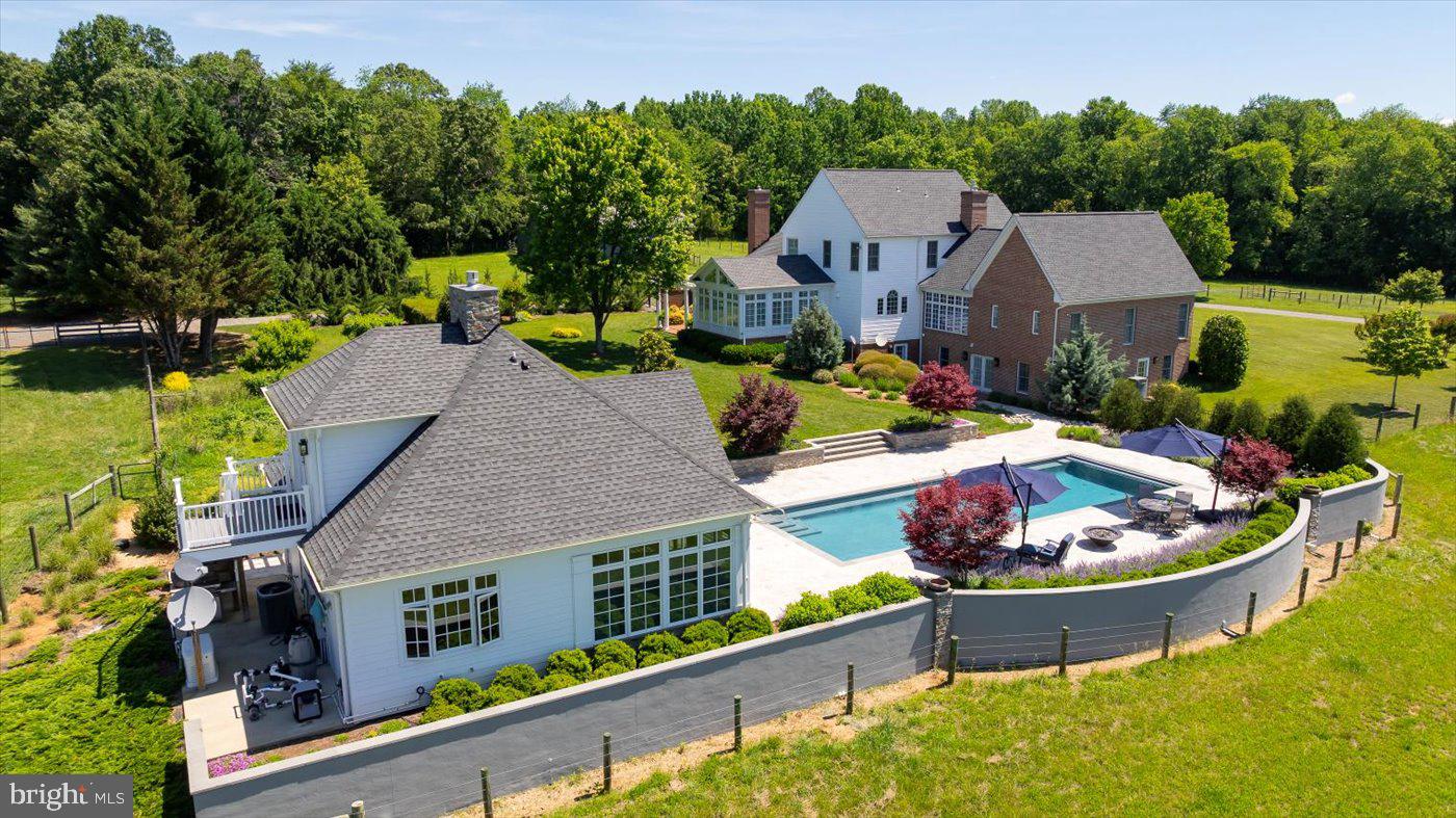 10042 Cedar Spring Lane Culpeper, VA 22701 - Photo 72 of 111 A stone wall lines one side of the pool area