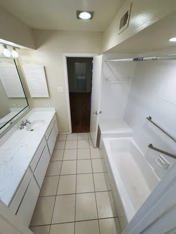 a bathroom with a sink a toilet and a shower
