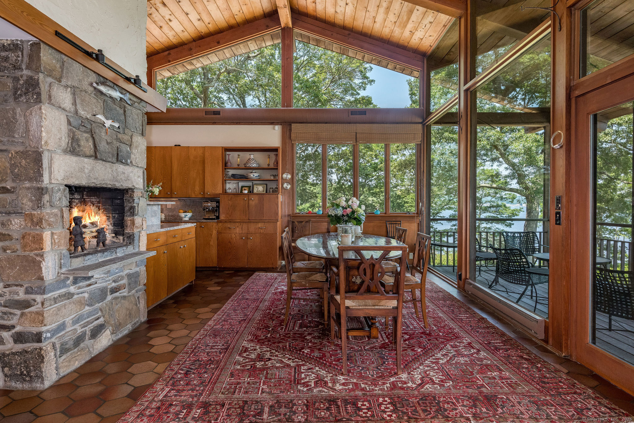 41 Watrous Point Road Old Saybrook, CT 06475 - Photo 17 of 40 Direct access to the deck from the dining room and nearby kitchen allows for a convenient al fresco option.