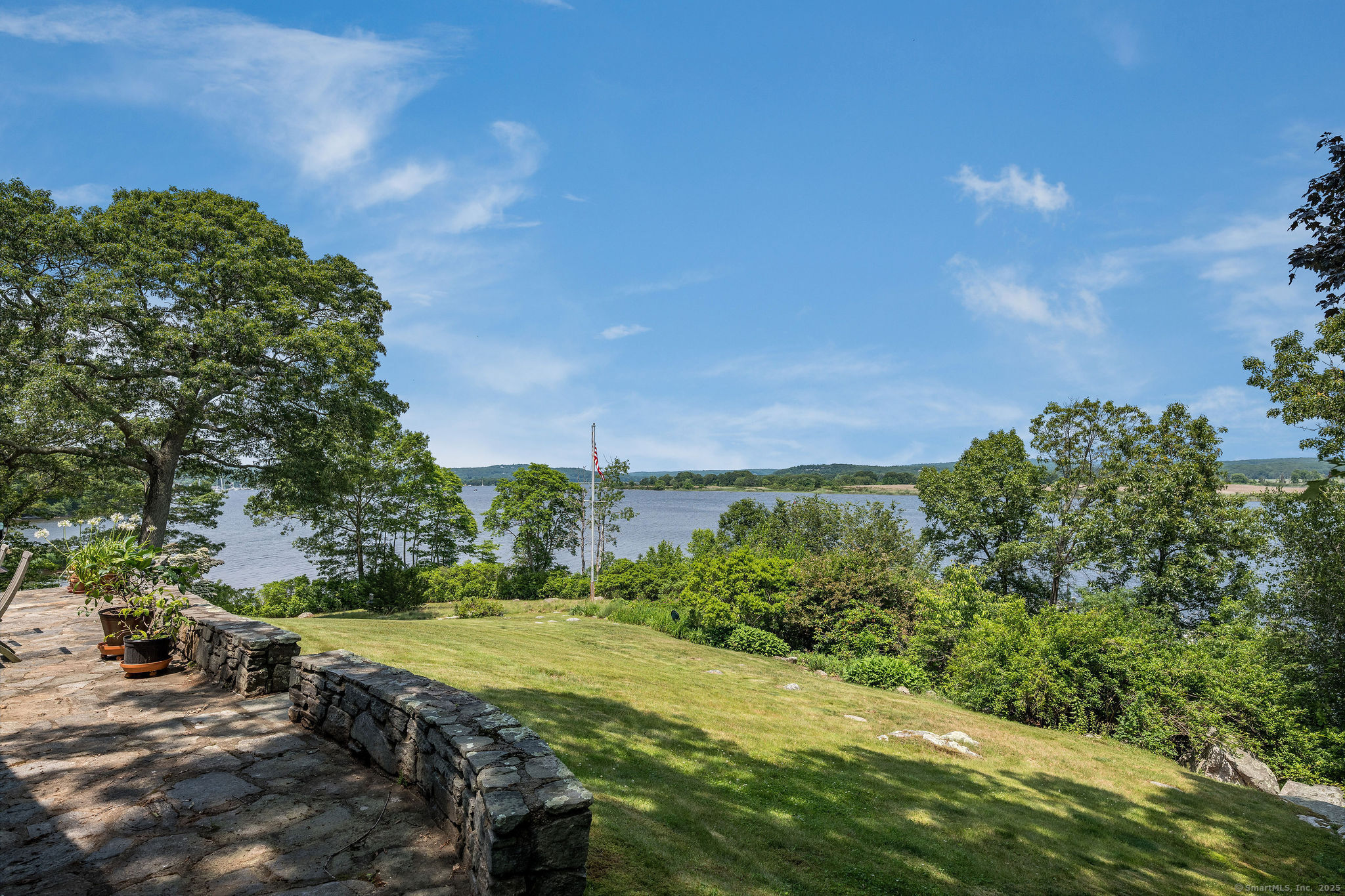41 Watrous Point Road Old Saybrook, CT 06475 - Photo 23 of 40 a view of a grassy area with an trees