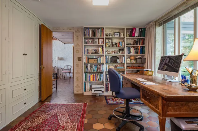 a bedroom with two beds and a large window