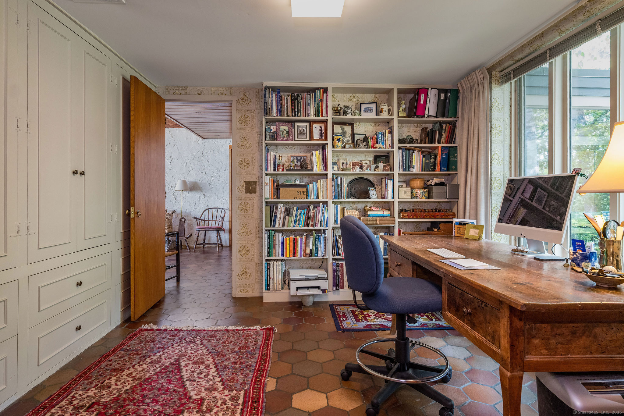 41 Watrous Point Road Old Saybrook, CT 06475 - Photo 24 of 40 a view of a workspace with furniture and a bookshelf
