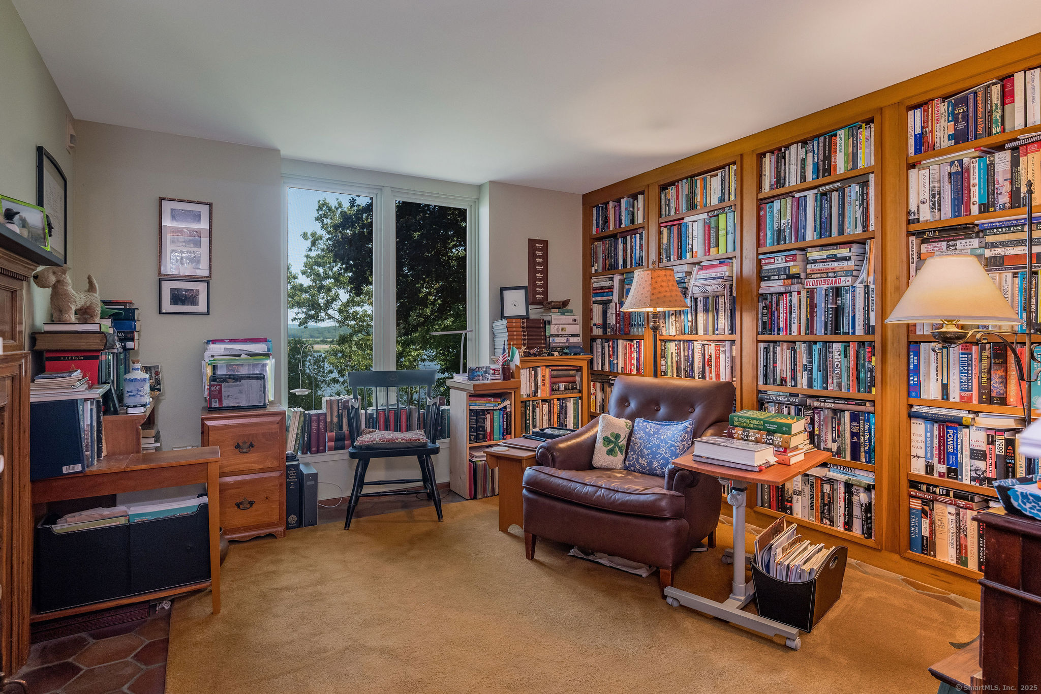 41 Watrous Point Road Old Saybrook, CT 06475 - Photo 26 of 40 a living room with furniture and a bookshelf