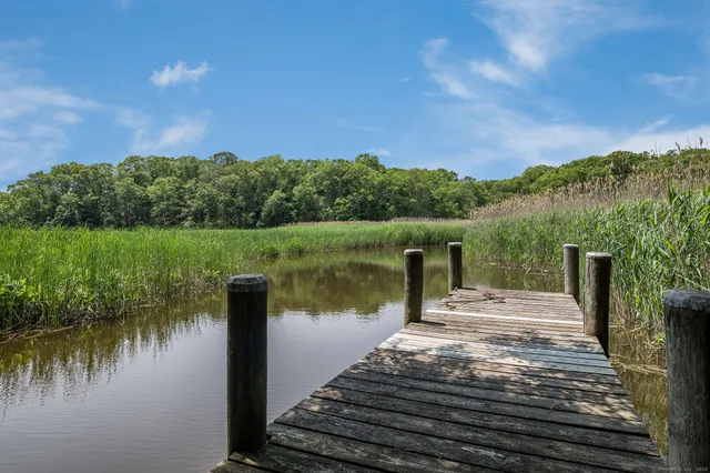 a swimming pool with outdoor seating and yard