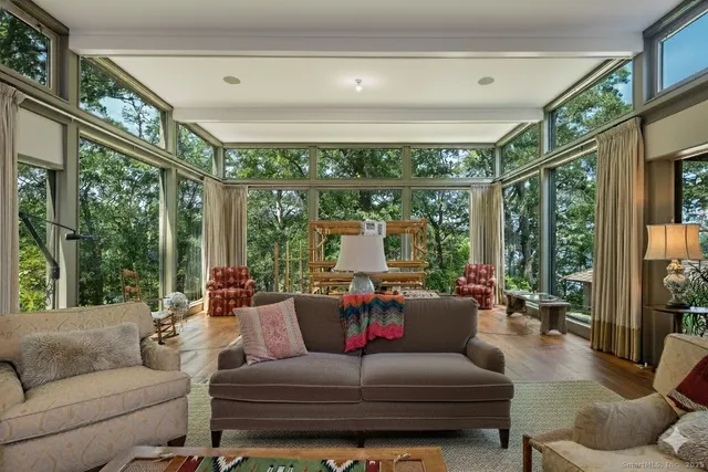 a view of a porch with furniture and a fireplace
