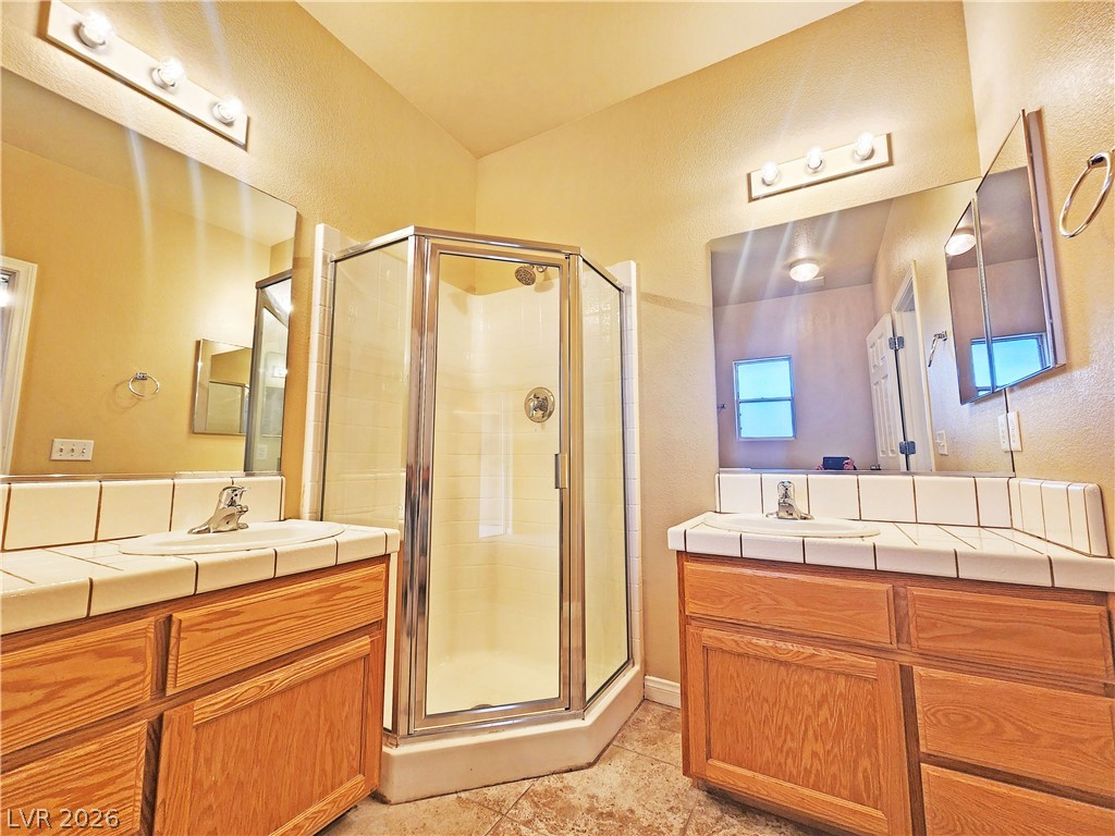 1421 Star Road, Unit 2 Pahrump, NV 89048 - Photo 25 of 33 Bathroom with a sink, a shower stall, and two vanities