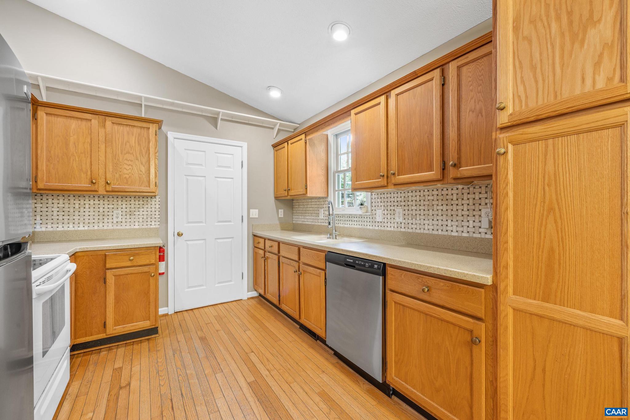 21 Ashton Road Palmyra, VA 22963 - Photo 12 of 35 a kitchen with stainless steel appliances granite countertop wooden cabinets a sink and a large window