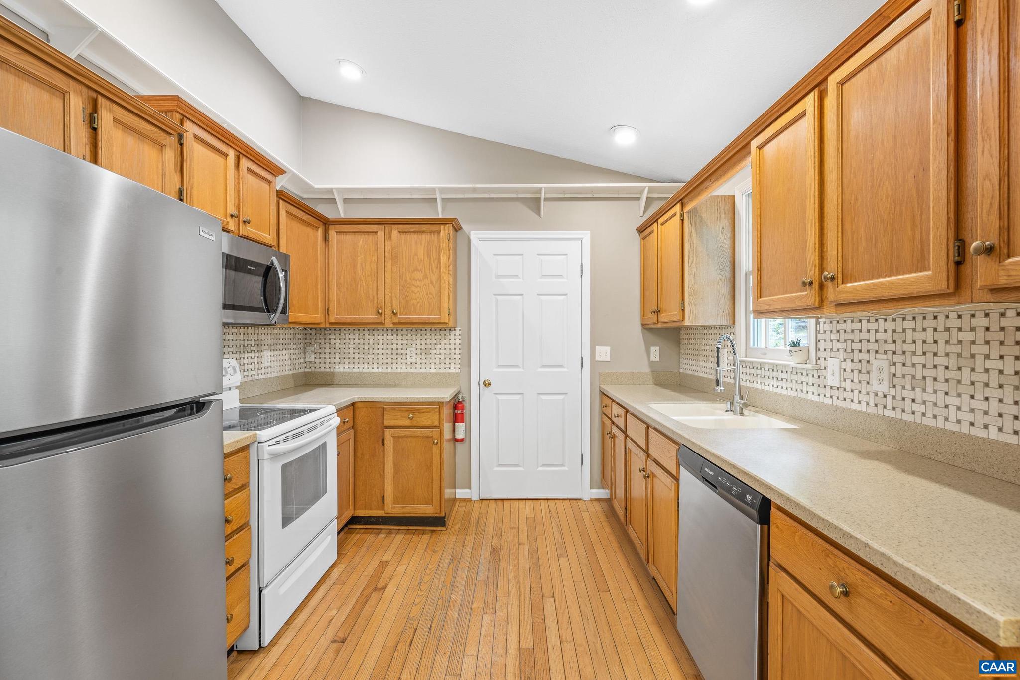 21 Ashton Road Palmyra, VA 22963 - Photo 13 of 35 a kitchen with stainless steel appliances granite countertop a refrigerator a sink dishwasher a stove and white countertops with wooden floor