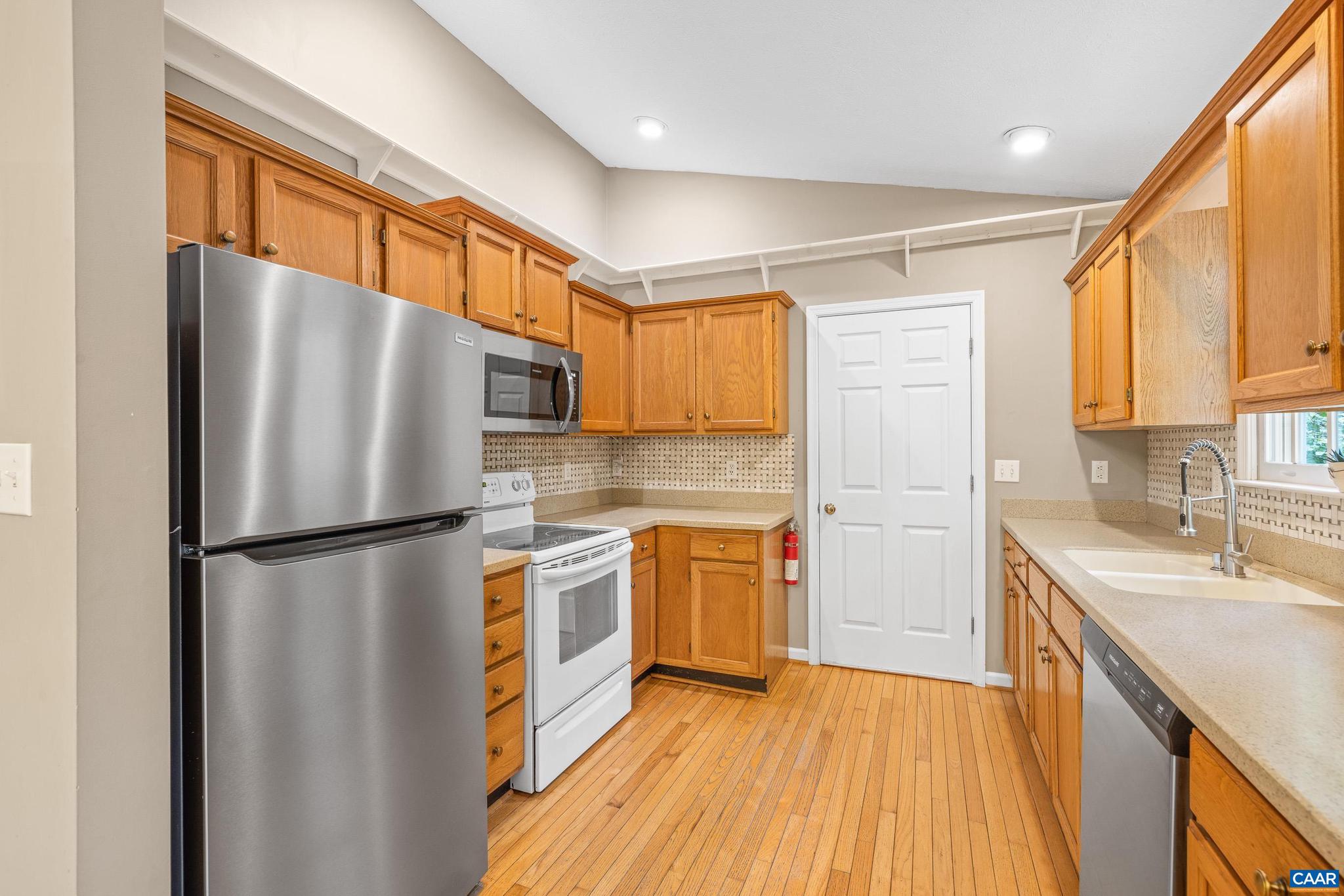 21 Ashton Road Palmyra, VA 22963 - Photo 14 of 35 a kitchen with stainless steel appliances granite countertop a refrigerator a sink dishwasher a stove with wooden cabinets and floor