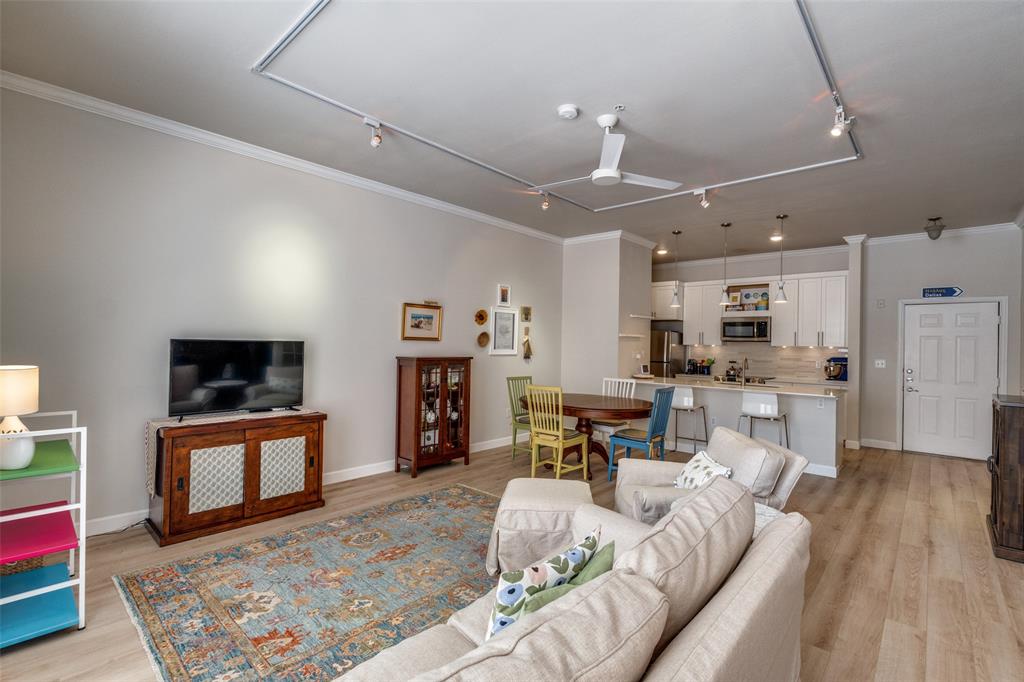 2305 Worthington Street, Unit 104 Dallas, TX 75204 - Photo 10 of 25 a living room with furniture and a flat screen tv