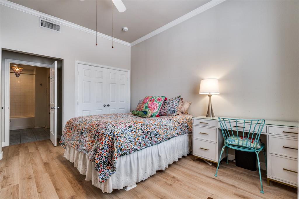 2305 Worthington Street, Unit 104 Dallas, TX 75204 - Photo 14 of 25 a bedroom with a bed and a table