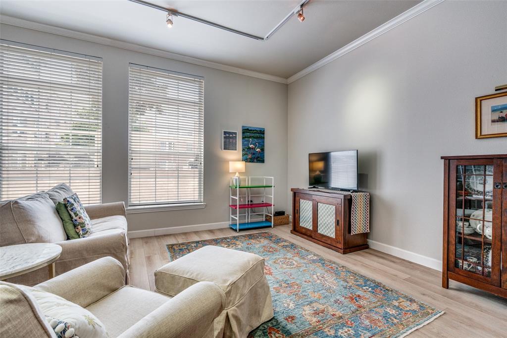 2305 Worthington Street, Unit 104 Dallas, TX 75204 - Photo 2 of 25 a living room with furniture and a flat screen tv