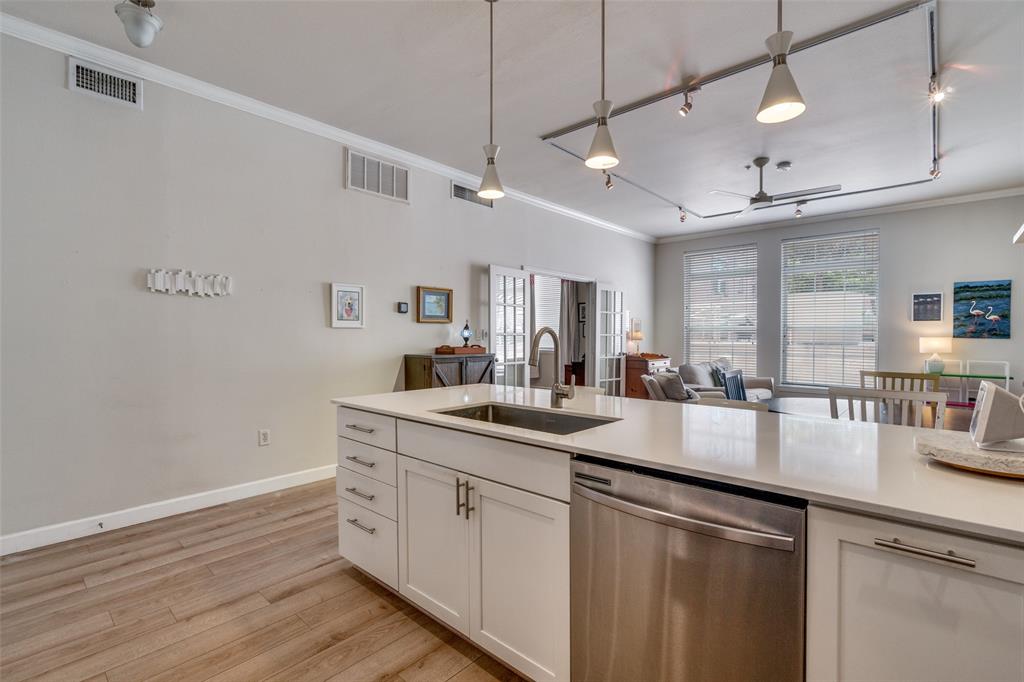 2305 Worthington Street, Unit 104 Dallas, TX 75204 - Photo 8 of 25 a kitchen with sink cabinets and wooden floor