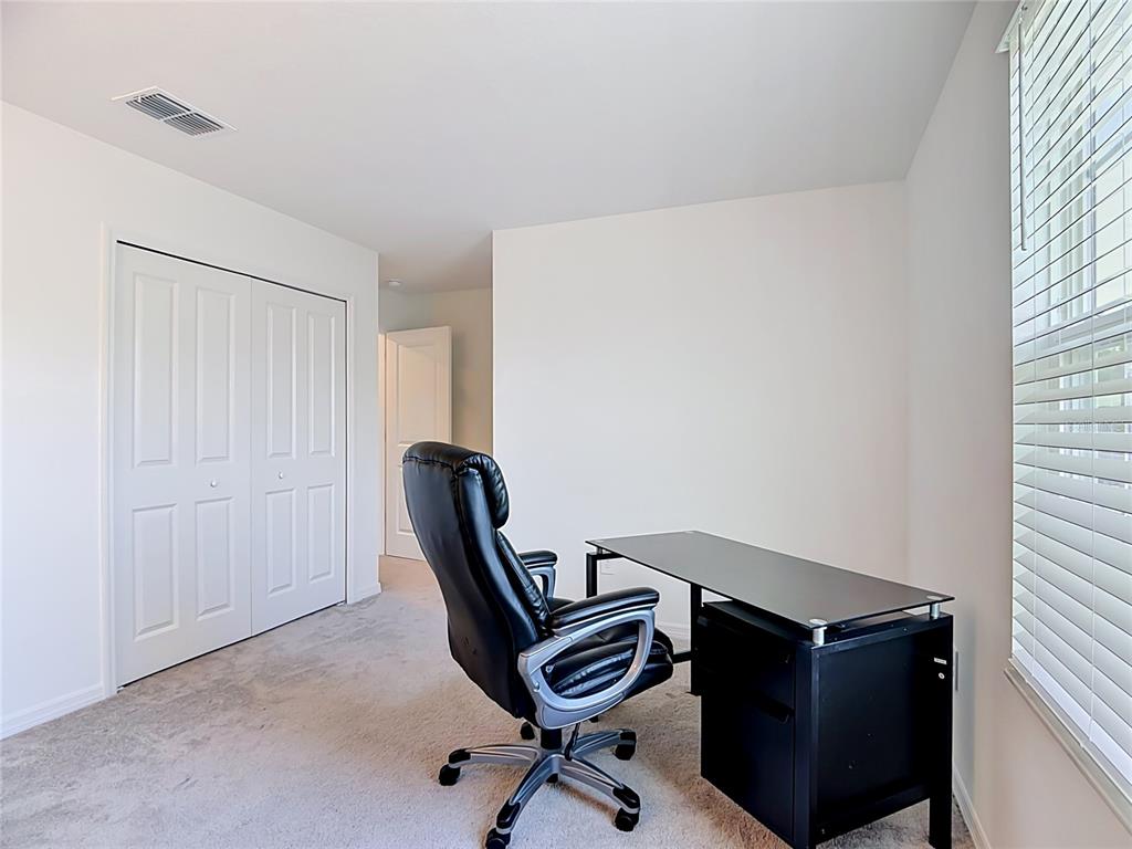 1633 Red Loop Lakeland, FL 33801 - Photo 39 of 60 a view of a workspace with furniture and a window